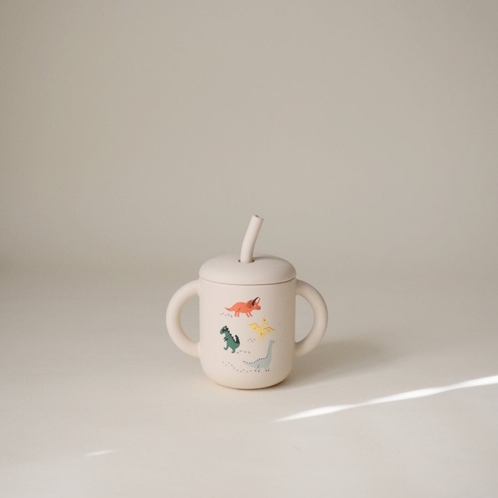 Mushie® Silikonski kozarček s slamico Dinosaurs Mushie